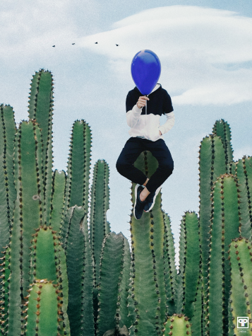 person sitting on top of cacti, holding blue ballon